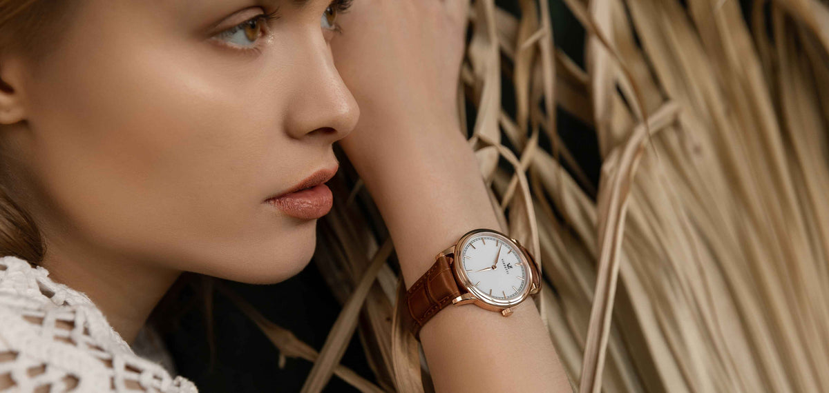 A model for Vizzetti showcasing a Vizzetti watch on her wrist.