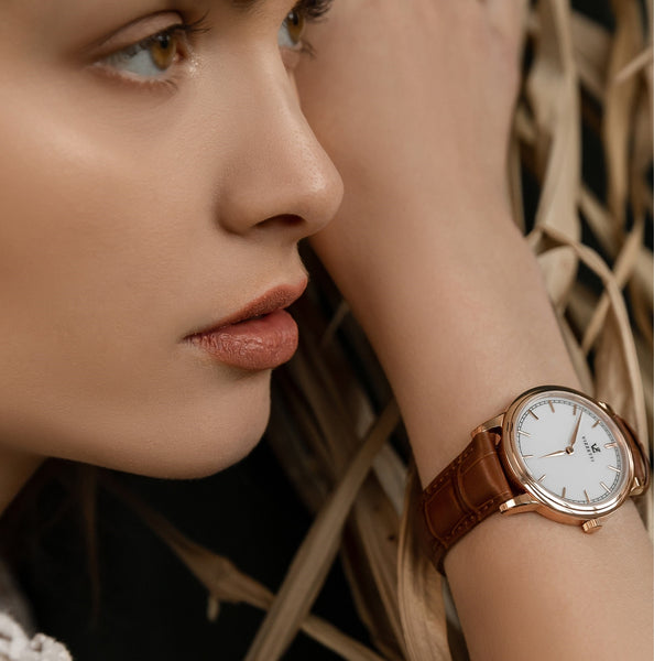 A model for Vizzetti showcasing a Vizzetti watch on her wrist.